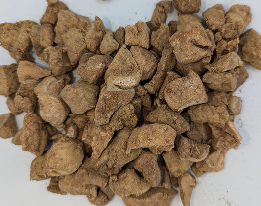 Close-up of brown pet food on a white background